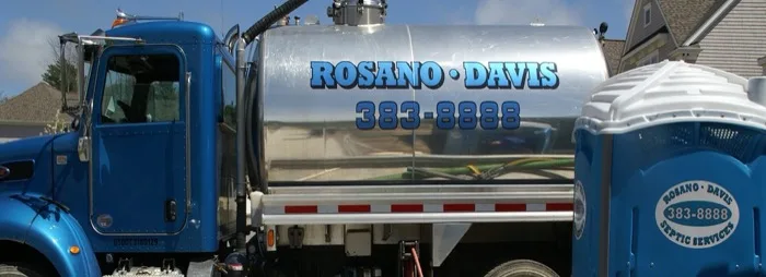 Close-up of a Rosano Davis tanker truck and portable toilet