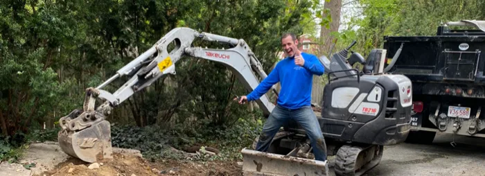 Rosano Davis crew member with excavation equipment on a septic repair job